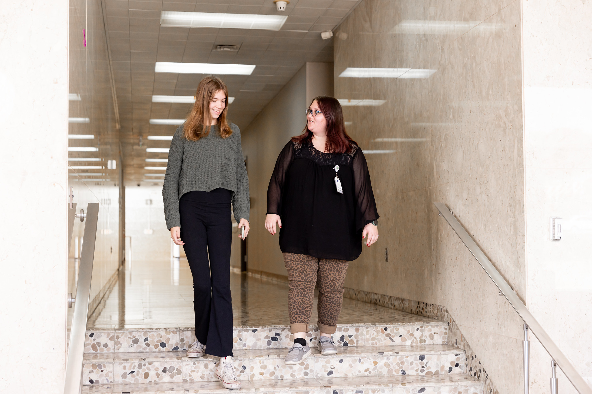 2 women walking down stairs