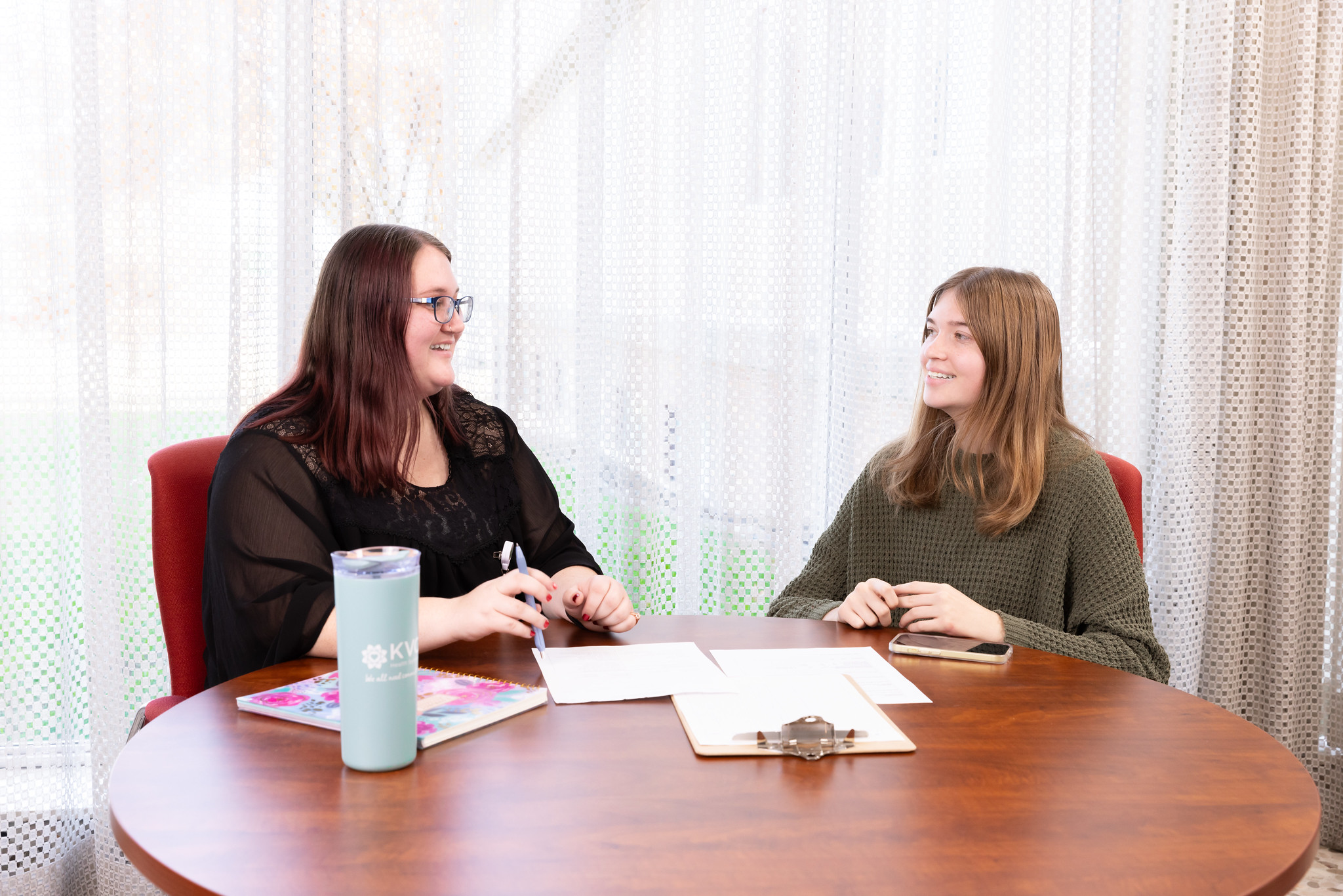 2 women talking at a table