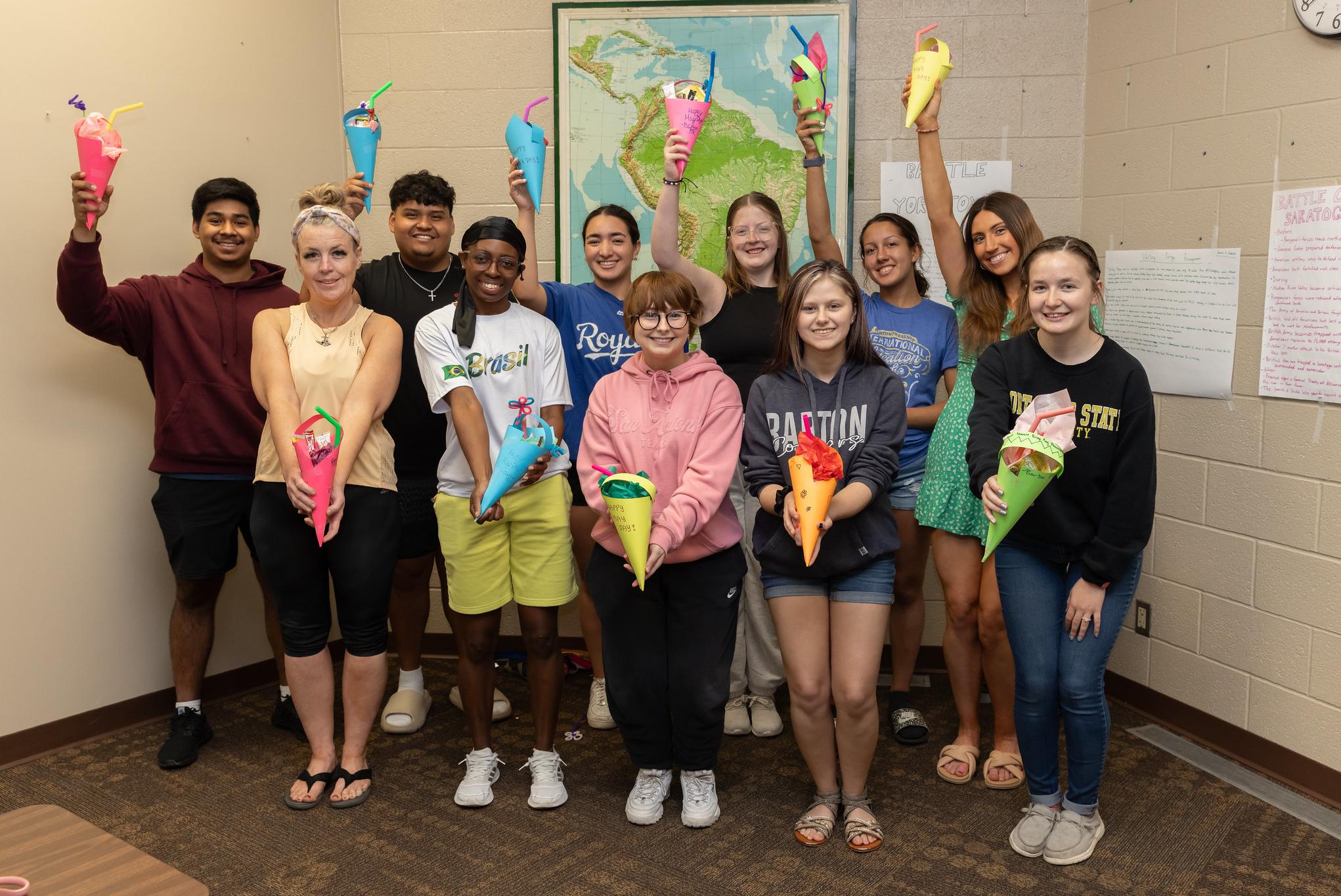 students holding paper baskets they made