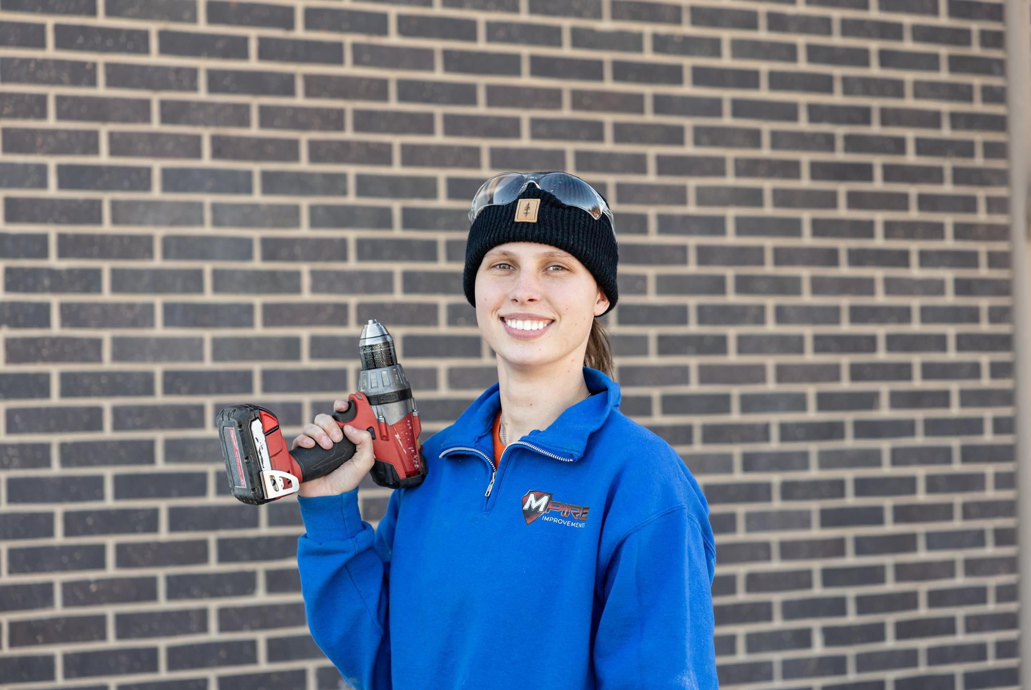 woman holding a drill